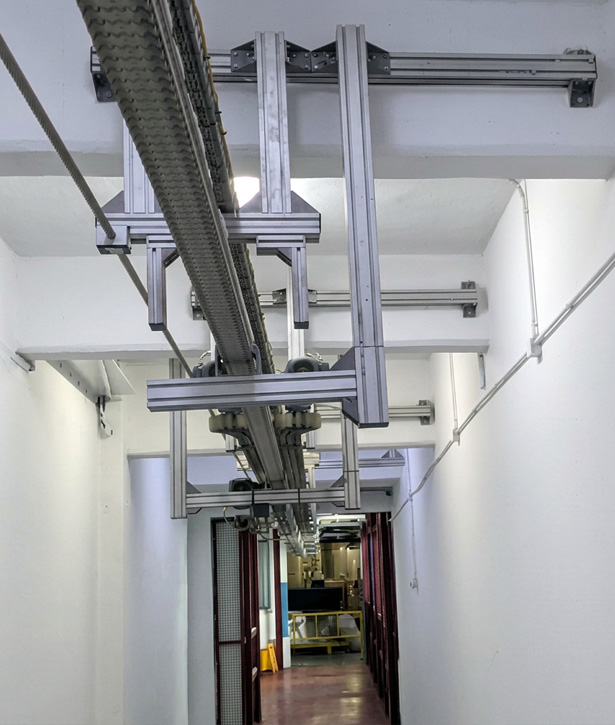 VERTIJET vertical air conveyor transporting PET bottles through confined spaces and tunnels while maximizing plant space utilization.