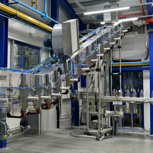 POSIJET and VERTIJET air conveyor systems transporting PET bottles through vertical and elevated sections of a high-speed bottling line.