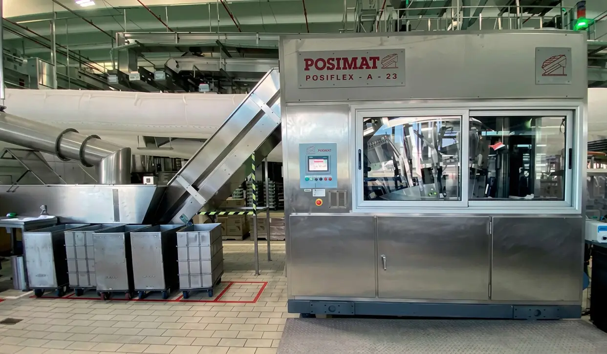 POSIMAT plastic bottle unscrambler integrated into an automated packaging line for high-efficiency bottle handling and feeding applications.