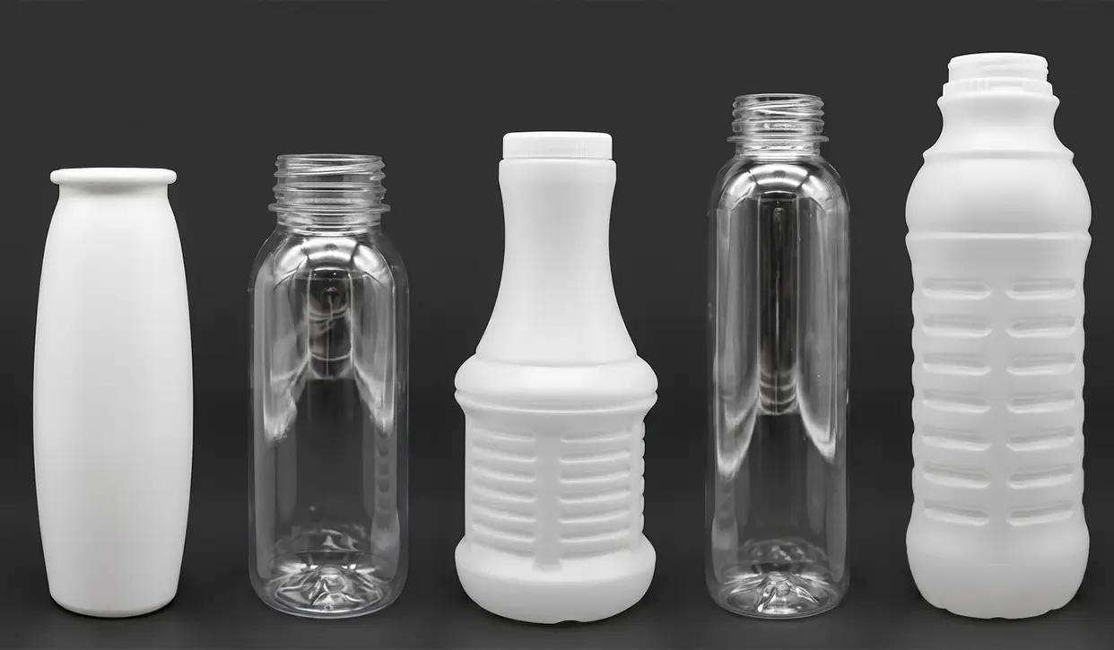 Plastic bottles for dairy packaging applications, including PET and HDPE containers processed with a POSIMAT bottle unscrambler for high-speed packaging lines.